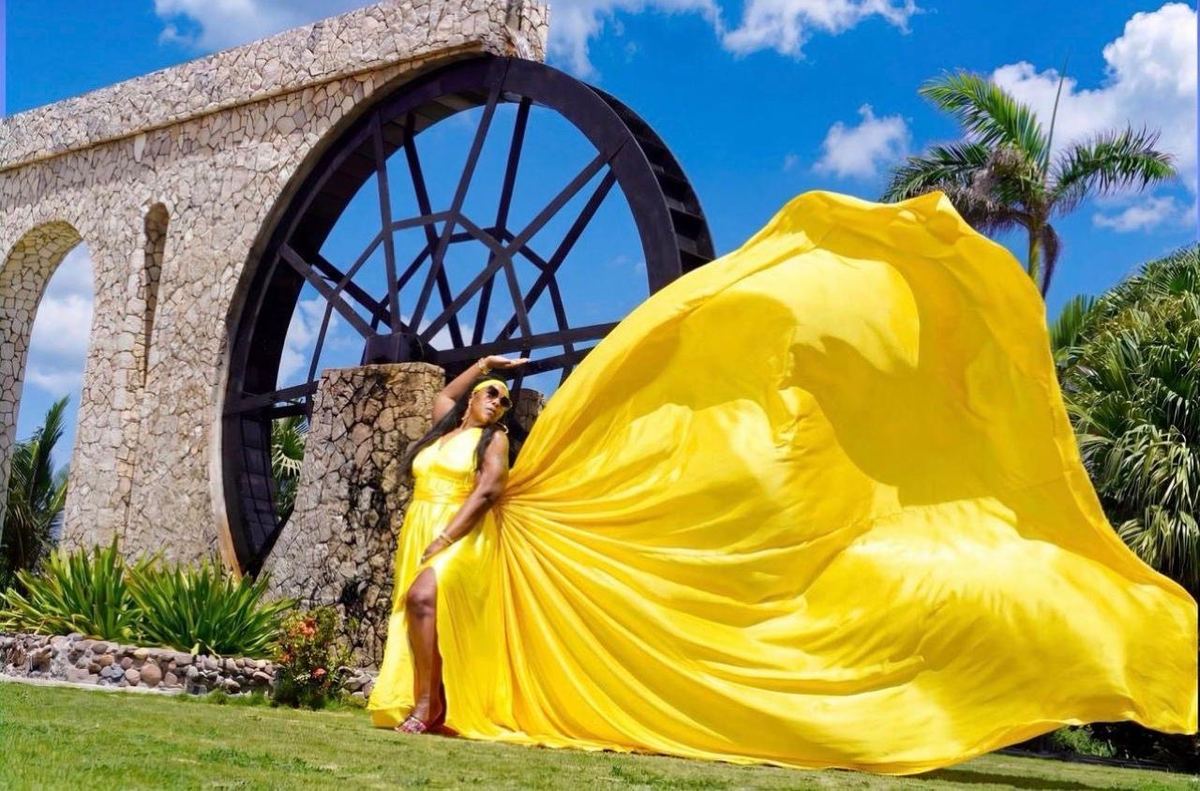 Flying yellow dress by the water wheel