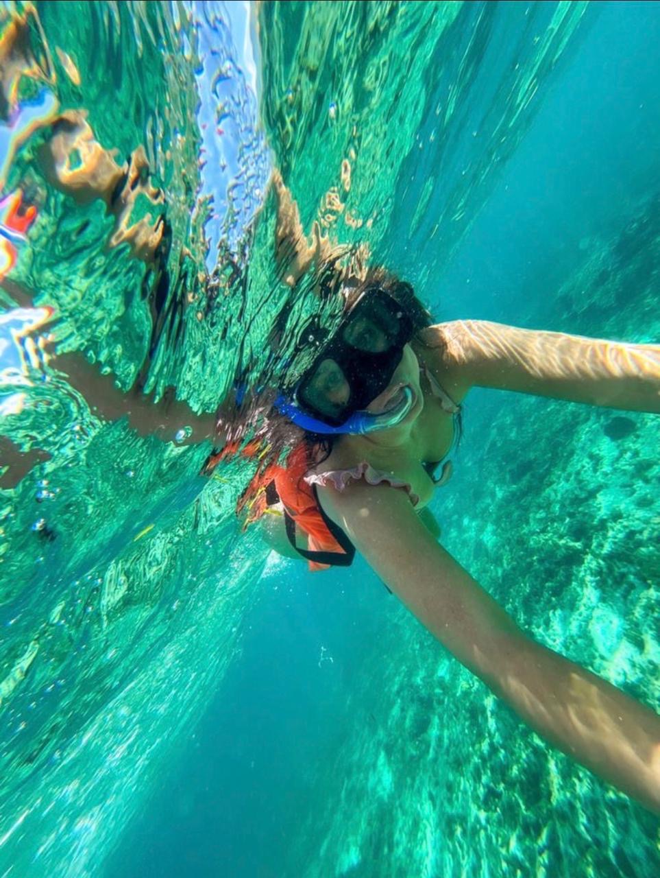 Guest snorkeling in clear turquoise water
